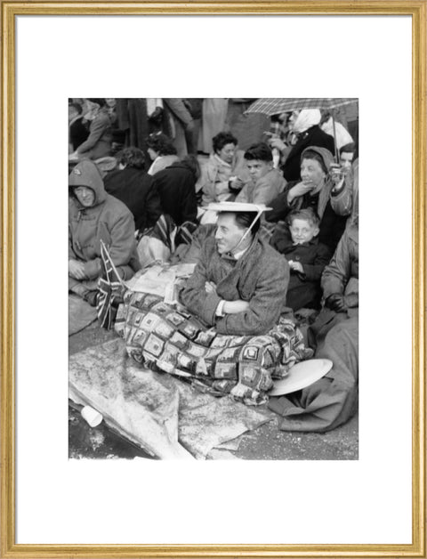 Spectators waiting on the pavement for Queen Elizabeth II's Coronation 1953