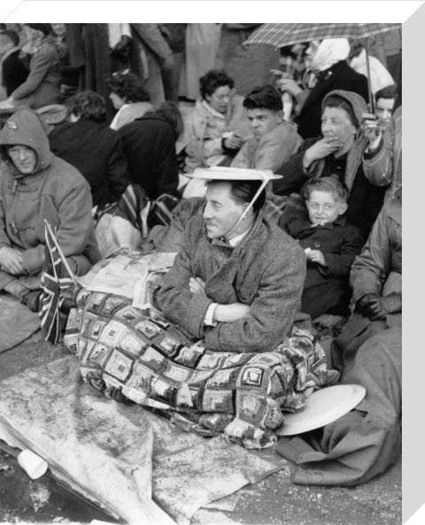 Spectators waiting on the pavement for Queen Elizabeth II's Coronation 1953