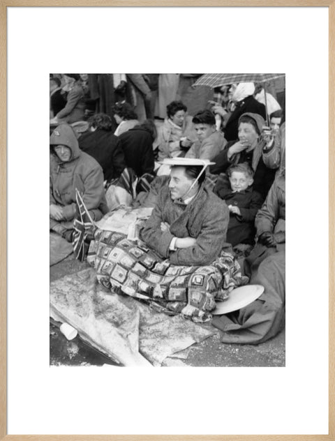 Spectators waiting on the pavement for Queen Elizabeth II's Coronation 1953