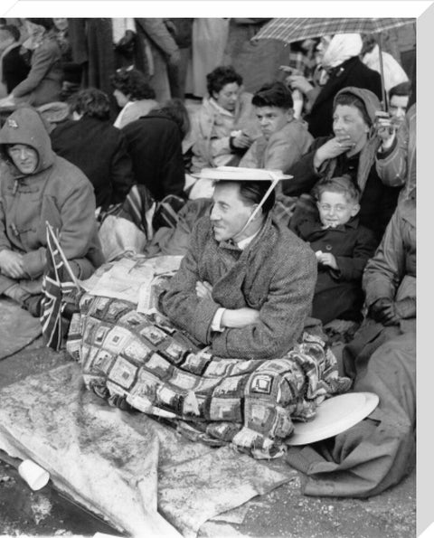 Spectators waiting on the pavement for Queen Elizabeth II's Coronation 1953