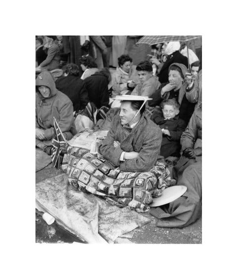 Spectators waiting on the pavement for Queen Elizabeth II's Coronation 1953