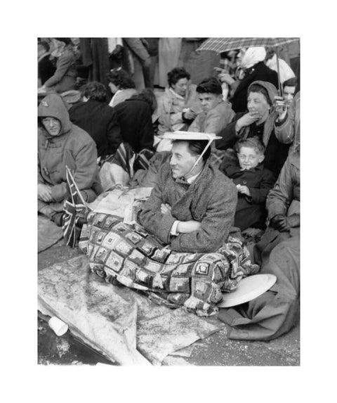 Spectators waiting on the pavement for Queen Elizabeth II's Coronation 1953