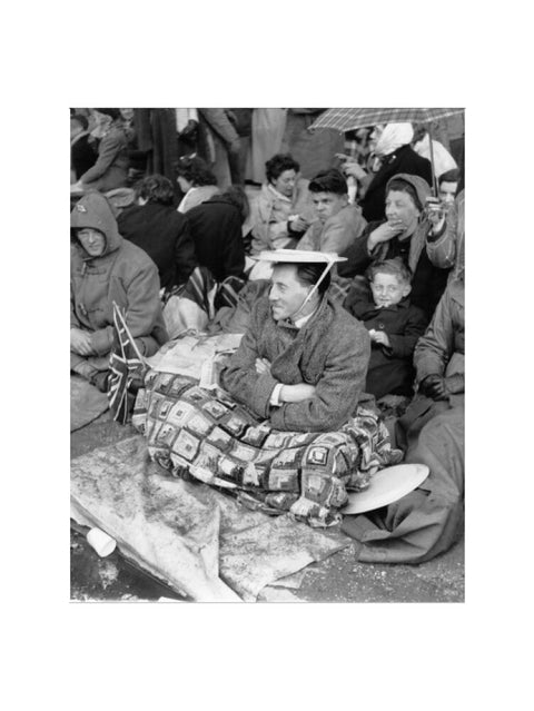 Spectators waiting on the pavement for Queen Elizabeth II's Coronation 1953