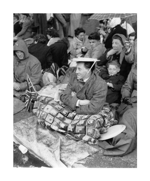 Spectators waiting on the pavement for Queen Elizabeth II's Coronation 1953