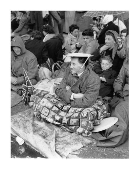 Spectators waiting on the pavement for Queen Elizabeth II's Coronation 1953