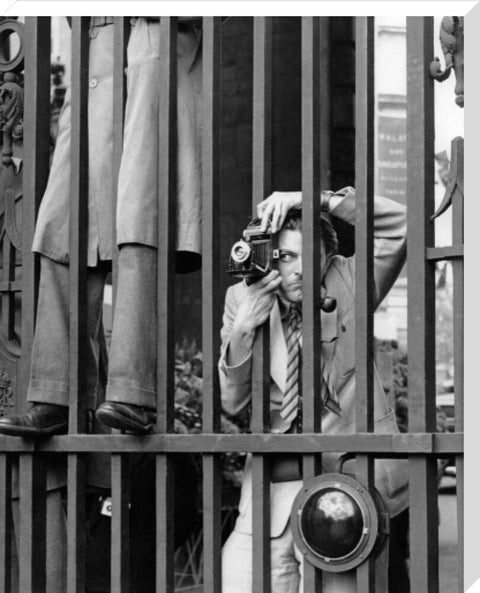 A photographer takes a picture through the railings at Admiralty Arch 1953