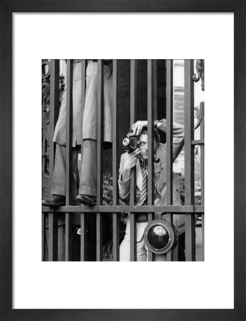 A photographer takes a picture through the railings at Admiralty Arch 1953