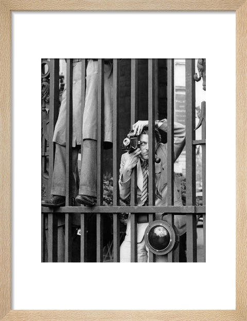 A photographer takes a picture through the railings at Admiralty Arch 1953