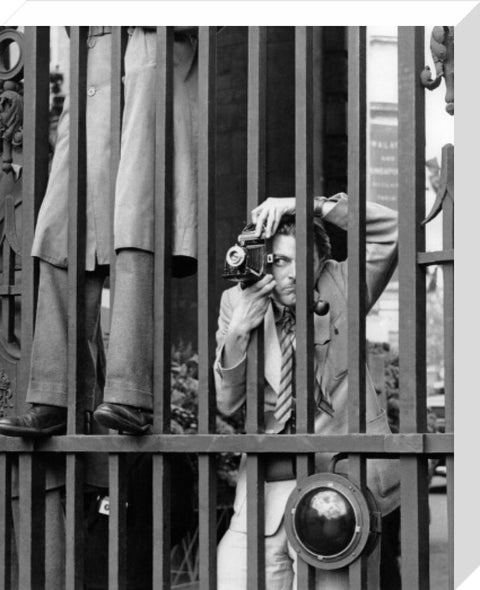 A photographer takes a picture through the railings at Admiralty Arch 1953