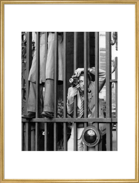 A photographer takes a picture through the railings at Admiralty Arch 1953