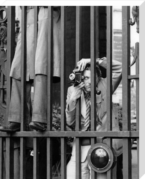 A photographer takes a picture through the railings at Admiralty Arch 1953