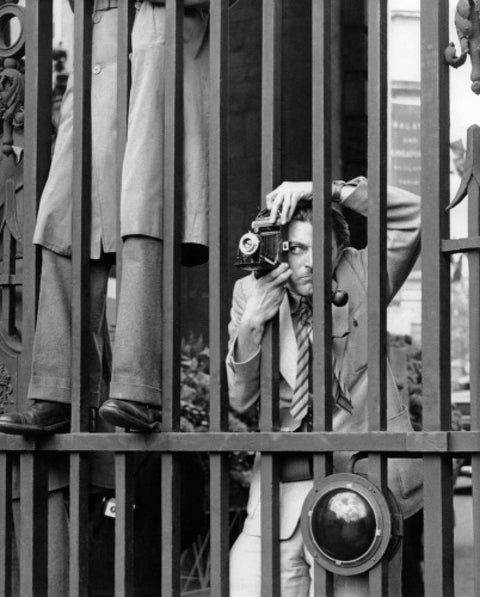 A photographer takes a picture through the railings at Admiralty Arch 1953