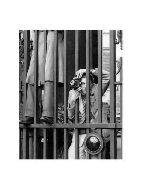 A photographer takes a picture through the railings at Admiralty Arch 1953