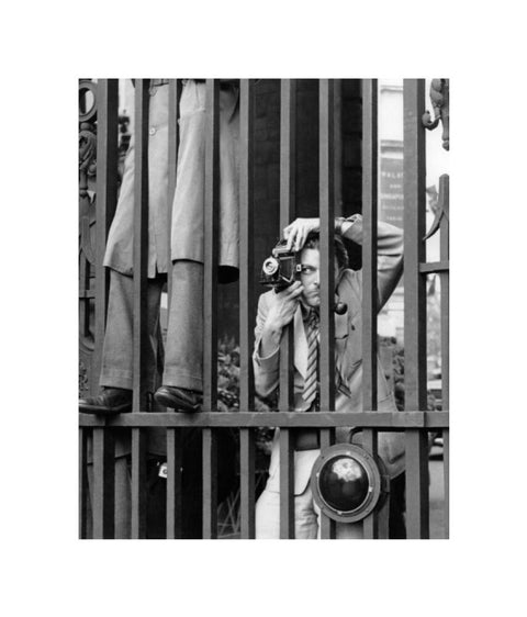 A photographer takes a picture through the railings at Admiralty Arch 1953