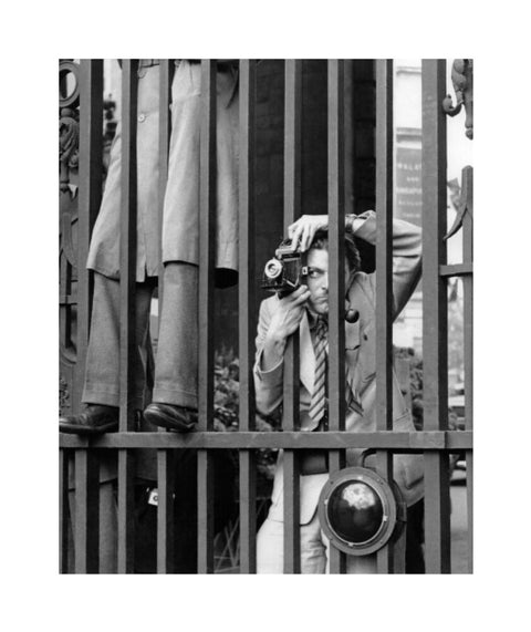 A photographer takes a picture through the railings at Admiralty Arch 1953