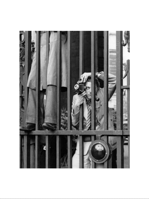 A photographer takes a picture through the railings at Admiralty Arch 1953