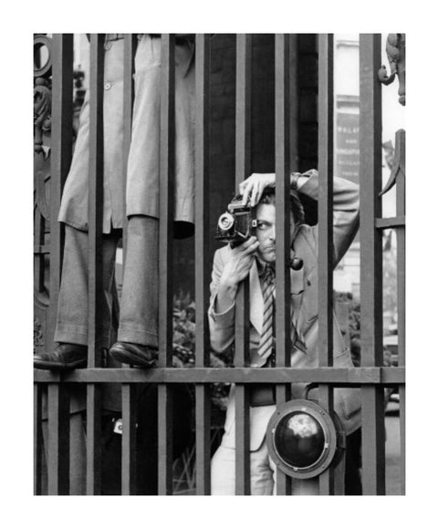 A photographer takes a picture through the railings at Admiralty Arch 1953