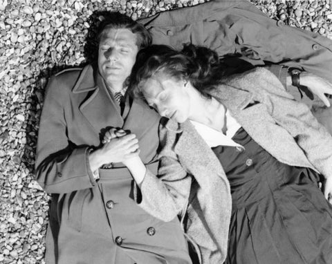 A couple lying together on Brighton Beach c. 1955