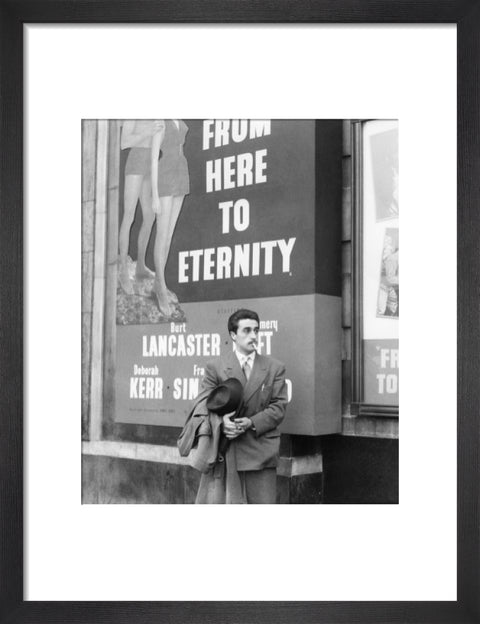 A man standing outside the Odeon cinema at Hyde Park Corner c. 1953