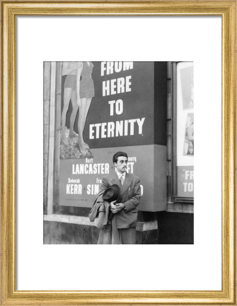 A man standing outside the Odeon cinema at Hyde Park Corner c. 1953