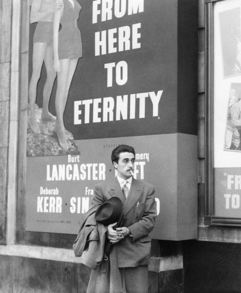 A man standing outside the Odeon cinema at Hyde Park Corner c. 1953