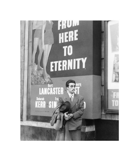 A man standing outside the Odeon cinema at Hyde Park Corner c. 1953