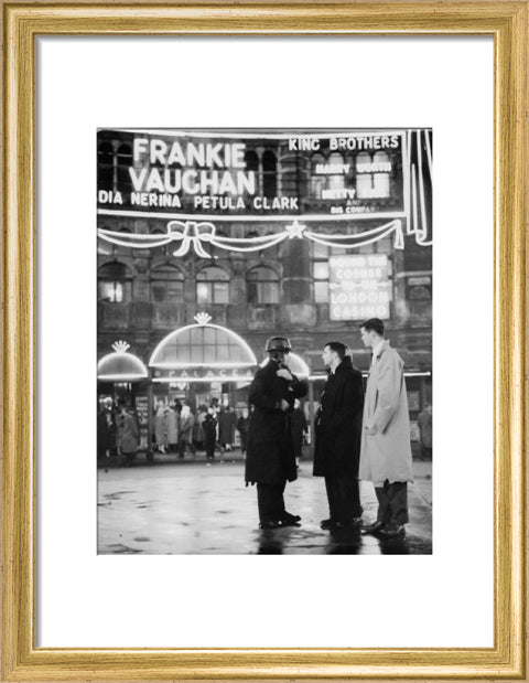 A group of men talking outside the Palace Theatre Shaftsbury Avenue c. 1955