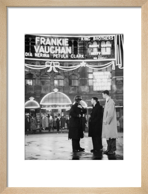 A group of men talking outside the Palace Theatre Shaftsbury Avenue c. 1955