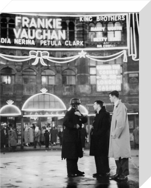 A group of men talking outside the Palace Theatre Shaftsbury Avenue c. 1955