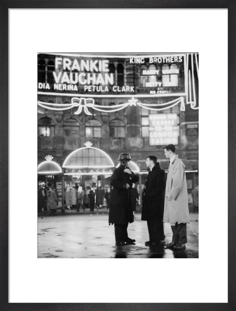 A group of men talking outside the Palace Theatre Shaftsbury Avenue c. 1955