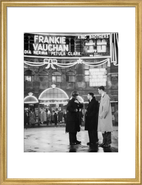 A group of men talking outside the Palace Theatre Shaftsbury Avenue c. 1955