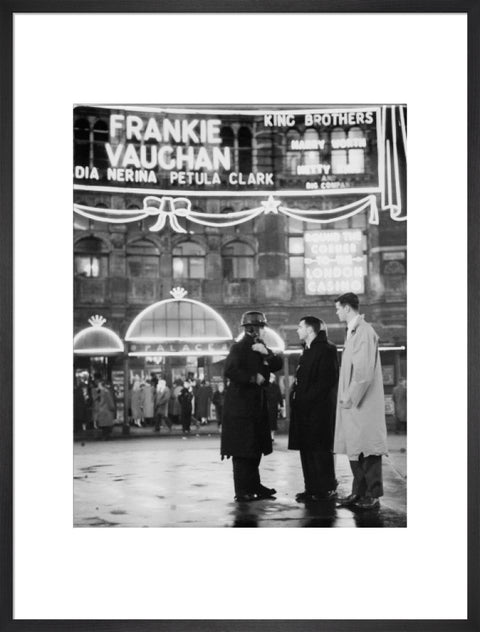 A group of men talking outside the Palace Theatre Shaftsbury Avenue c. 1955