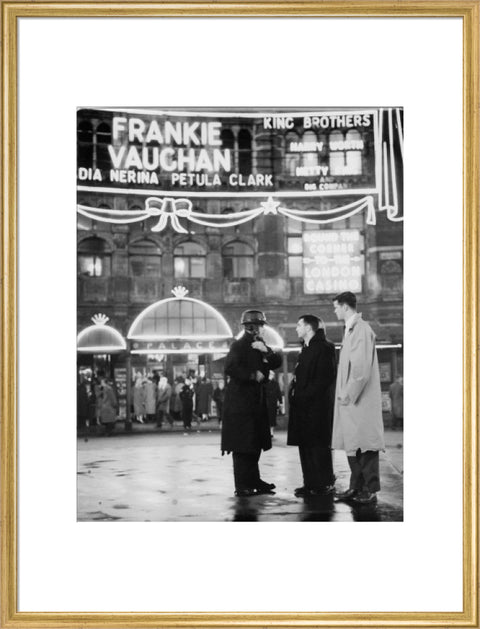 A group of men talking outside the Palace Theatre Shaftsbury Avenue c. 1955