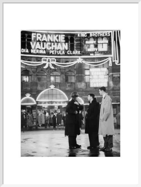 A group of men talking outside the Palace Theatre Shaftsbury Avenue c. 1955