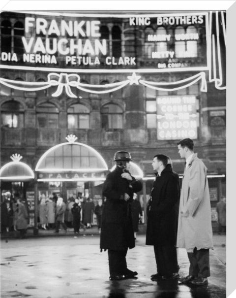 A group of men talking outside the Palace Theatre Shaftsbury Avenue c. 1955