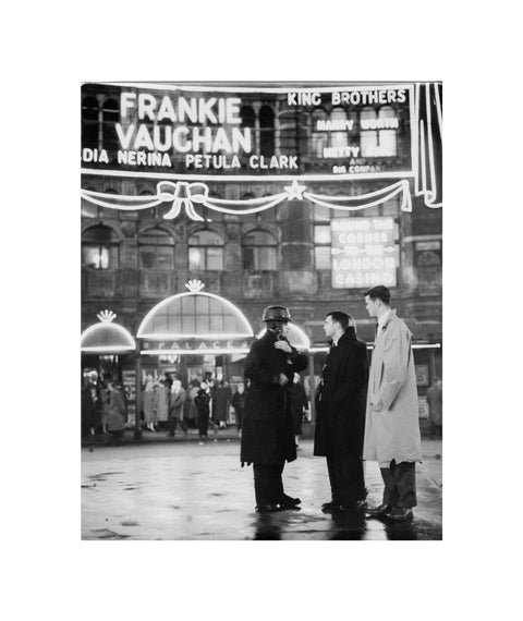 A group of men talking outside the Palace Theatre Shaftsbury Avenue c. 1955