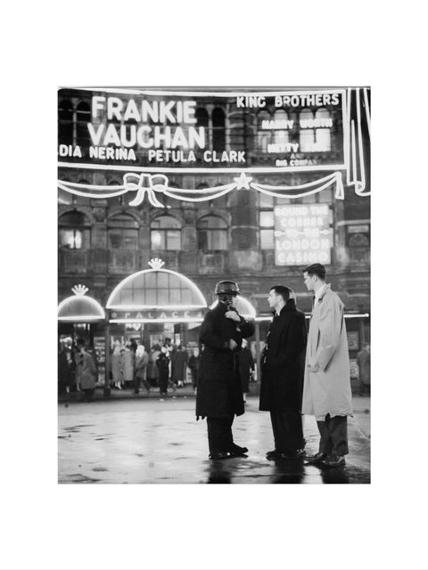 A group of men talking outside the Palace Theatre Shaftsbury Avenue c. 1955