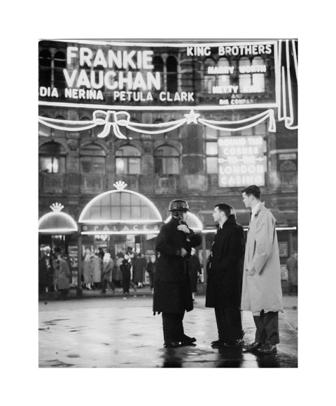 A group of men talking outside the Palace Theatre Shaftsbury Avenue c. 1955