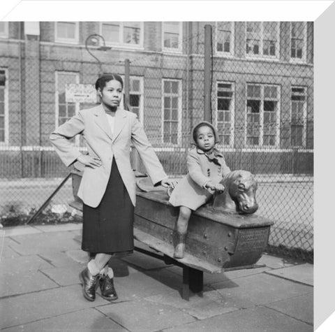 East London Afro-Caribbean child and mother in playground 1952