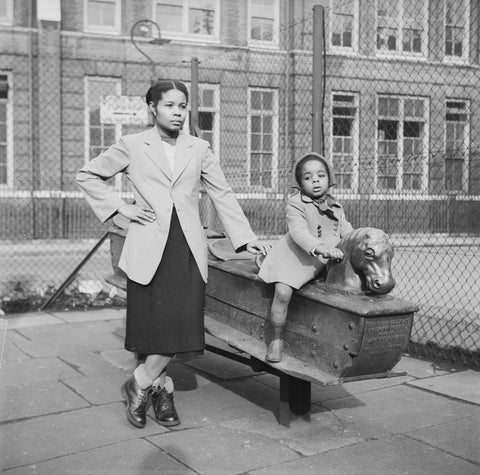 East London Afro-Caribbean child and mother in playground 1952