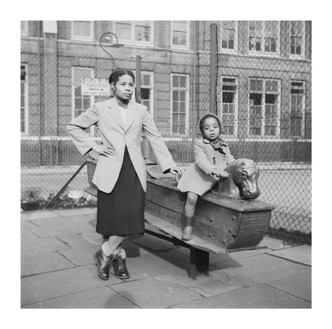 East London Afro-Caribbean child and mother in playground 1952