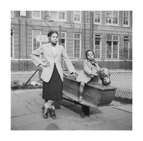 East London Afro-Caribbean child and mother in playground 1952