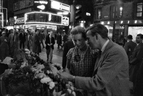 Man buying a woman a flower in the West End 1960