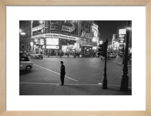 Lone man in Piccadilly at night 1960