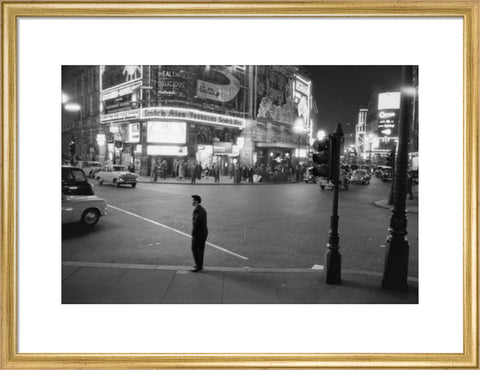 Lone man in Piccadilly at night 1960