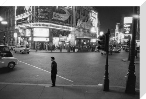 Lone man in Piccadilly at night 1960