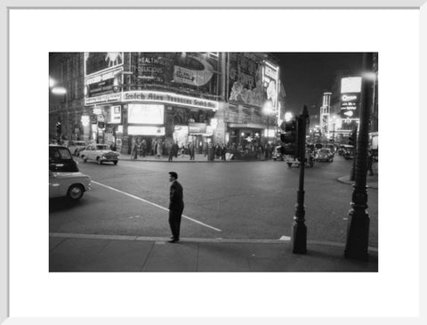 Lone man in Piccadilly at night 1960