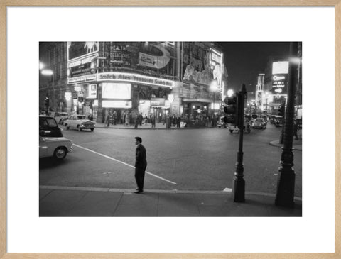 Lone man in Piccadilly at night 1960