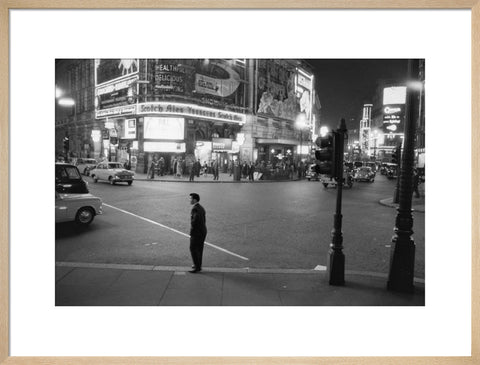 Lone man in Piccadilly at night 1960