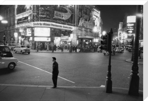 Lone man in Piccadilly at night 1960